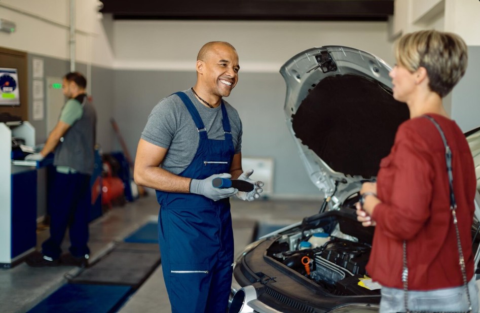 Auto service advisor speaking with a customer in a repair shop