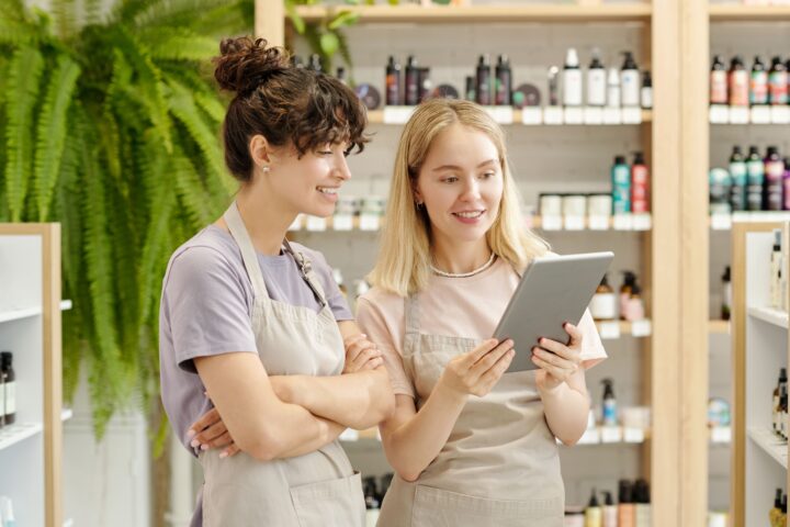 Salon staff reviewing appointments on a tablet in a wellness business