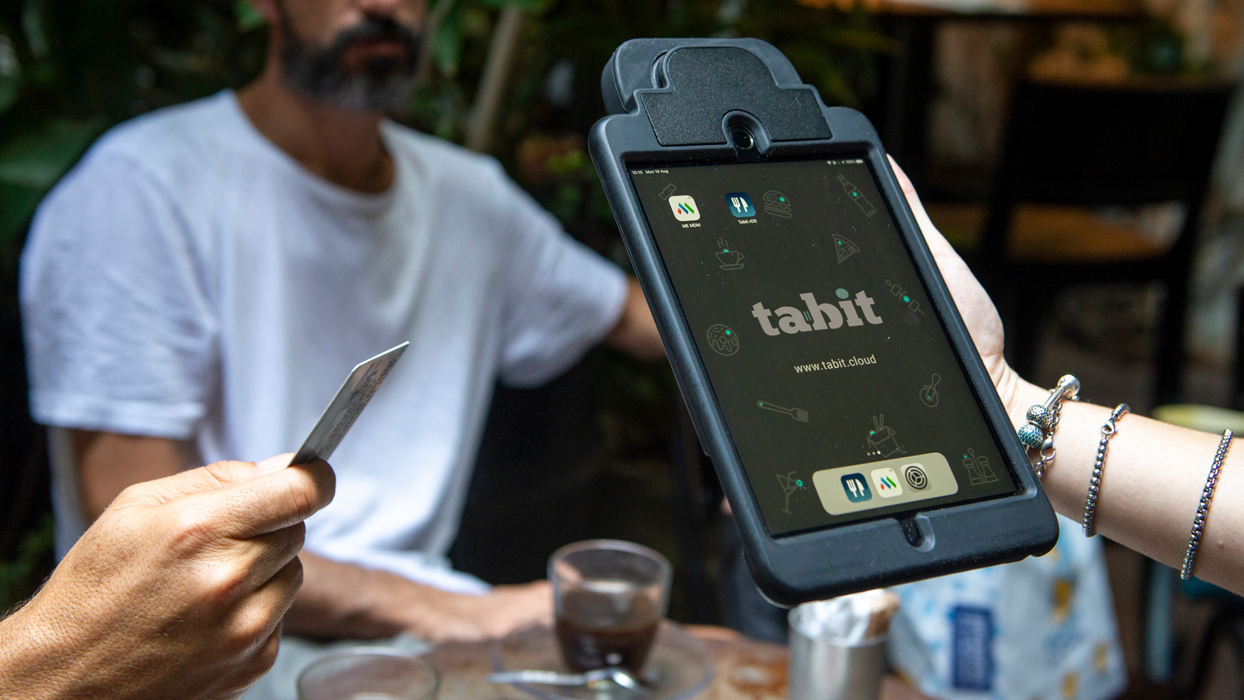 Server wearing a Tabit mobile POS pouch during restaurant service