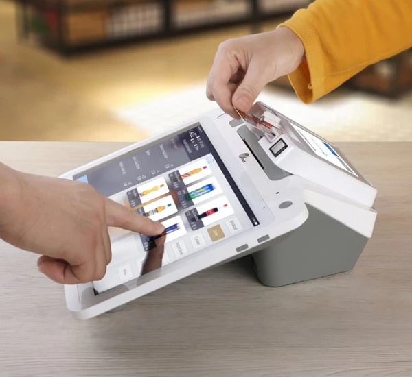 PAX E700 countertop POS used for checkout in a service business